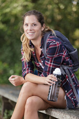 a woman hiker drinking water