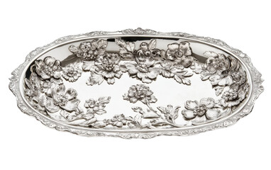 Silver plate with a floral design sits on a white background
