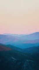 Obraz premium Serene Mountain Landscape at Dusk with Soft Pastel Hues and Delicate Layers of Rolling Hills Under a Tranquil Sky