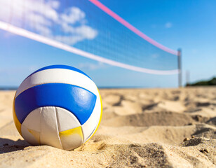 beach volleyball rests on sandy shore, with net in background under clear blue sky. scene captures essence of summer fun and outdoor sports