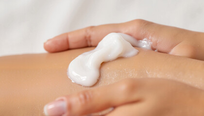 Hand rubbing lotion on legs while relaxing at home  