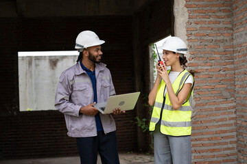 Two Engineer builder. Foreman use notebook computer working in construction site.	