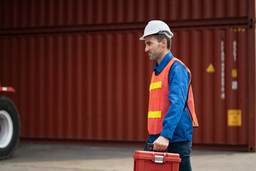 Caucasian man engineer worker working with toolbox and talking together at container site	