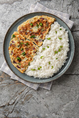 Spicy Kerala coconut ginger omelette Motta Porrichu with rice closeup on the plate on the table. Vertical top view from above