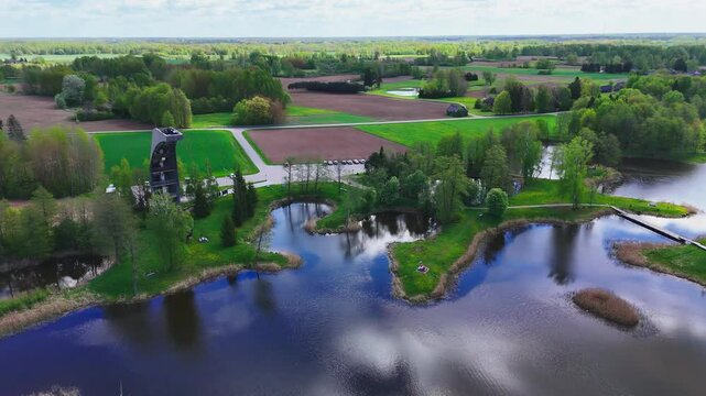 Kirkilai Observation Tower, Biržai Regional Park, Lithuania - A Beautiful View Highlights Winding Walkways, Peaceful Karst Lakes, and Lush, Densely Wooded Areas - Aerial Pullback Shot