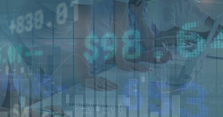 Image of financial data and graphs over midsection of diverse businesspeople working in office