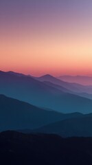 Fototapeta premium Serene Sunset Over Mountain Range with Layered Hills and Soft Gradient Sky Colors in Peaceful Natural Setting