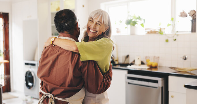 Dancing, cooking and senior couple hug in house kitchen for bonding, marriage relationship and romance. Retirement, laughing and happy elderly people in home for supper, lunch and dinner together