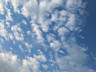 Blue Skies with wispy lines and fluffy white clouds