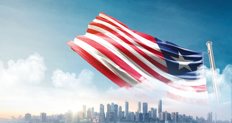 Liberia national flag waving with skyline and buildings.