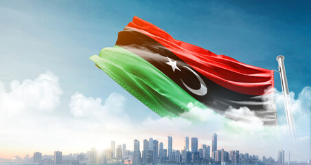 Libya national flag waving with skyline and buildings. Libya national flag for independence day. © Muhammad Arif