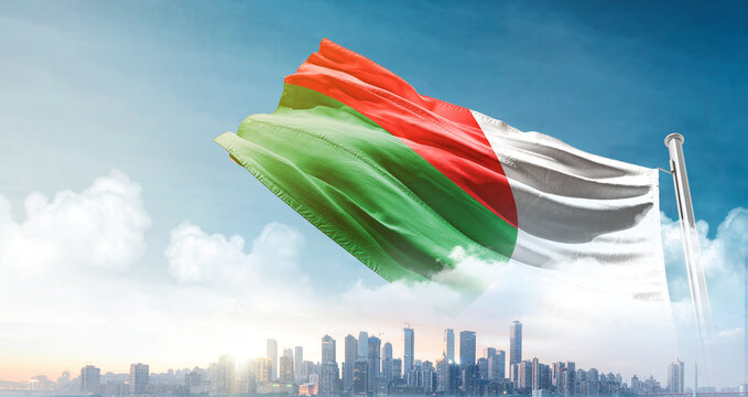 Madagascar  national flag waving with skyline and buildings. Madagascar national flag for independence day.