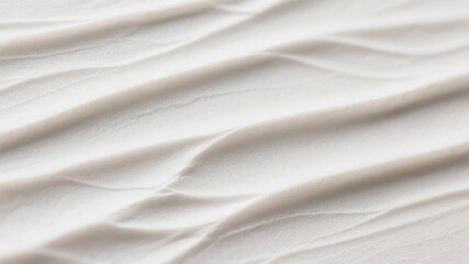 Soft white fabric showing gentle waves and subtle textural details for a smooth background