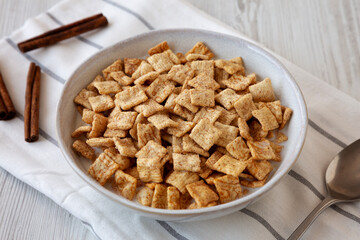 Crunchy Cinnamon Sugar Breakfast Cereal with Milk in a Bowl, side view.