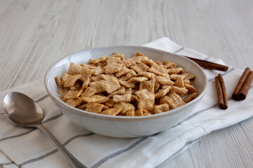 Crunchy Cinnamon Sugar Breakfast Cereal with Milk in a Bowl, side view.