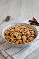 Crunchy Cinnamon Sugar Breakfast Cereal with Milk in a Bowl, side view.