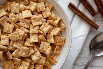 Crunchy Cinnamon Sugar Breakfast Cereal with Milk in a Bowl, top view.