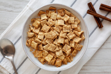 Crunchy Cinnamon Sugar Breakfast Cereal with Milk in a Bowl, top view.