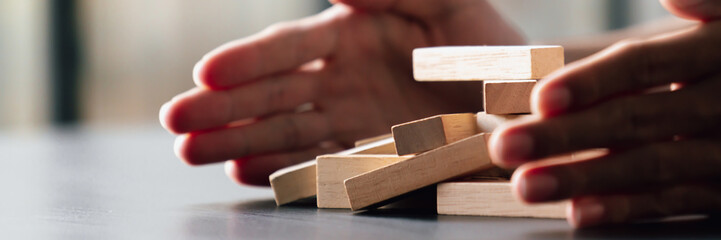 business man protect wooden brick planning risk management