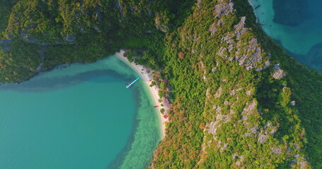 Breathtaking aerial view showcasing the pristine beauty of Mu Ko Ang Thong National Park in Thailand, featuring crystal-clear turquoise waters, lush tropical vegetation, and a secluded beach