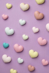 Colorful tiny hearts on pastel purple background. Minimal concept idea. Place for inscription.
