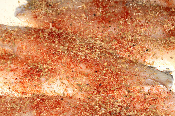 Fototapeta premium Close up of seasoned and herb fish waiting to be cooked