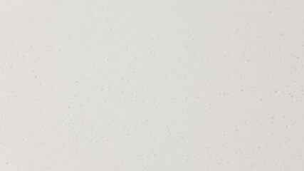 Close up texture detail of white quartz surface exhibiting subtle speckled appearance