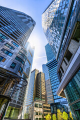 Low angle view of the modern office skyscrapers at the City of Frankfurt am Main, Germany, with reflections on the glass facades