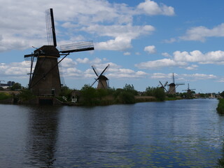 line of windmills by the canal, kinderdijk, NL