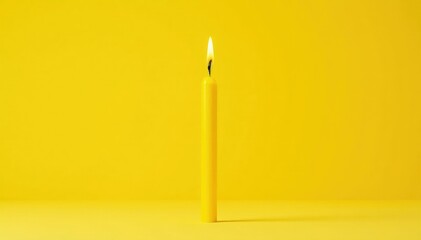 Single yellow birthday candle against vibrant yellow background, single candle, golden
