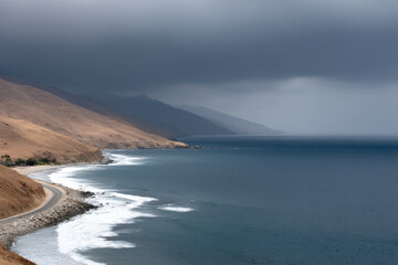 coastal cliff in afghanistan under dramatic storm clouds rich color tones