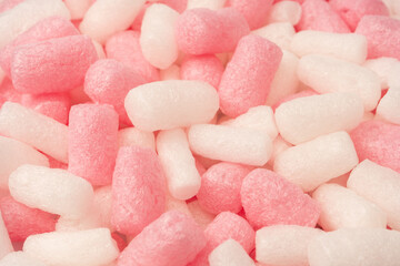 Pink and white box filler as a background. Top view.