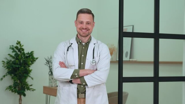 Medical professional wearing white lab coat, stethoscope, standing confidently with crossed arms, smiling warmly inside sleek hospital environment, representing healthcare expertise