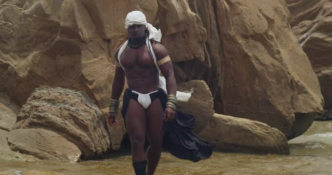 The beach is graced by a male cosplayer, dark-skinned and muscled.