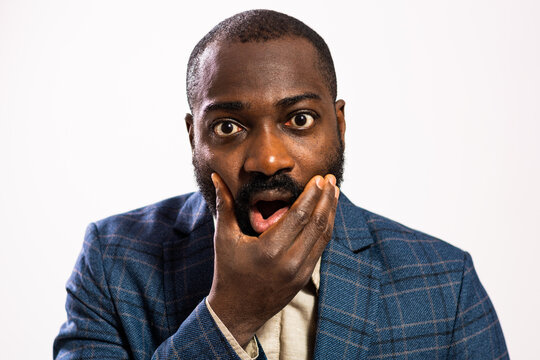 Close up portrait of businessman who is shocked.