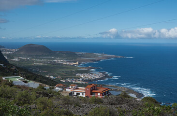 Aerial view of colorful houses near old town Garachico from Mirador de Garachico view point.. Green cean shore with lava rocks. Popular tourist destination, Tenerife Canary Islands.