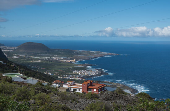 Aerial view of colorful houses near old town Garachico from Mirador de Garachico view point.. Green cean shore with lava rocks. Popular tourist destination, Tenerife Canary Islands.