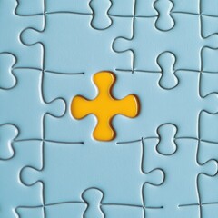 Fototapeta premium Puzzle completion concept showing yellow piece fitting into blue jigsaw from above representing solution strategy