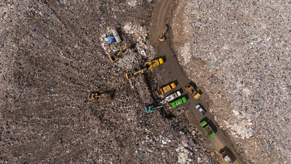 Trucks are collecting waste in large piles for disposal and recycling.	