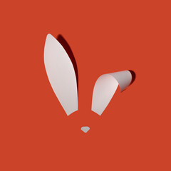 Rabbit ears from white paper on orange background. Easter minimal concept. Flat lay.
