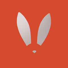 Rabbit ears from white paper on orange background. Easter minimal concept. Flat lay.
