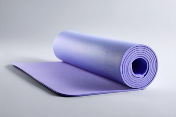 Purple Yoga Mat Rolled Up on Grey Background. Exercise Mat for Fitness, Pilates & Workout. Home Gym Equipment. Yoga & Stretching Photography.