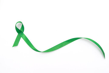 Green awareness ribbon symbolizing mental health support on a white background