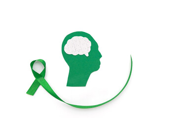 paper cutout green Human Head with with puzzle brain and Green Ribbon on white Background Representing Mental Health Awareness