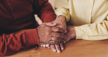 Home, table and old couple with holding hands for empathy, support and comfort to partner with grief. Closeup, senior people and love with sympathy for loss, compassion and kindness with commitment