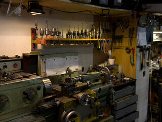 Lathe Operation in a Well-Equipped Workshop With Various Tools and Accessories on Display