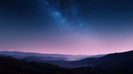 Fototapeta premium Night sky above a distant mountain range.