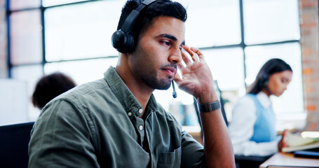 Burnout, headache and stress with man in call center for assistance, feedback or problem solving....