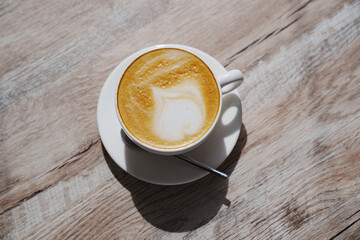 White classic cup with coffee and foam.