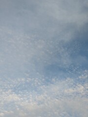 Blue Skies with wispy lines and fluffy white clouds
